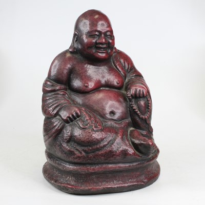 Lot 253 - A red glazed concrete figure of a seated...