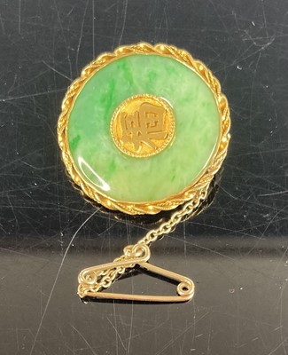 Lot 371 - A Chinese yellow metal and jade disc brooch,...