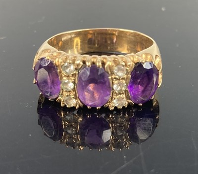 Lot 396 - A heavy 9ct gold amethyst three stone ring,...