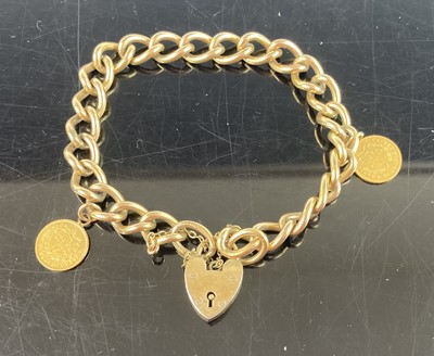 Lot 398 - A rolled gold curb link bracelet with heart...