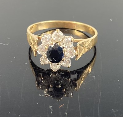 Lot 400 - A modern 9ct gold and CZ set flower head...