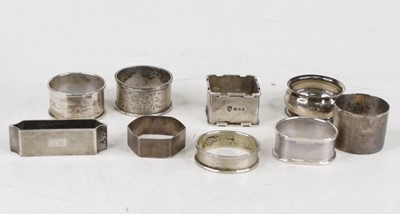 Lot 354 - A collection of nine silver napkin rings,...