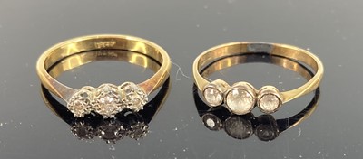 Lot 438 - An 18ct gold and diamond three stone ring,...