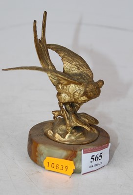 Lot 565 - A gilt metal model of a bird, mounted upon a...