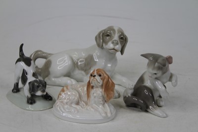 Lot 570 - A collection of four porcelain models of cats...