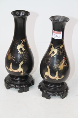 Lot 582 - A pair of Chinese gilt and black lacquer vases,...