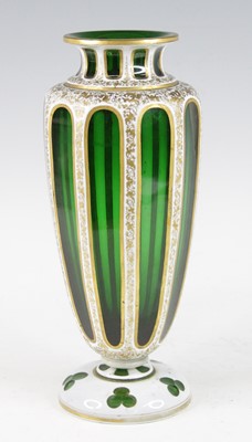 Lot 2055 - A Bohemian green and white overlaid glass vase,...