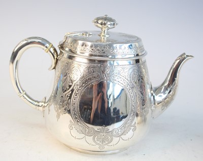 Lot 2092 - A Victorian silver teapot and matching cream,...