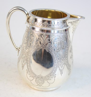 Lot 2092 - A Victorian silver teapot and matching cream,...