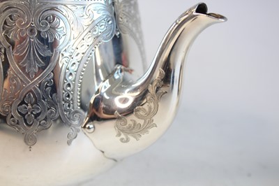 Lot 2092 - A Victorian silver teapot and matching cream,...