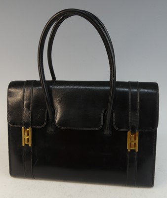 Lot 602 - A Hermès black leather drag-up handbag,...