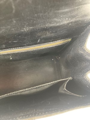 Lot 602 - A Hermès black leather drag-up handbag,...
