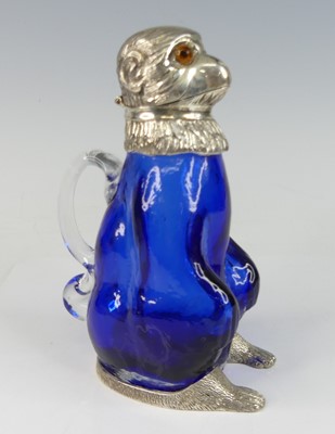 Lot 2147 - An EPNS and blue glass claret jug in the form...