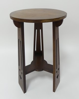 Lot 770 - An Arts & Crafts walnut circular occasional...