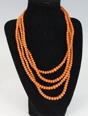 Lot 2164 - A four-row coral necklace, with 111, 113, 119...