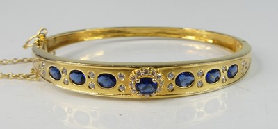 Lot 2216 - A yellow metal sapphire oval hinged hollow...