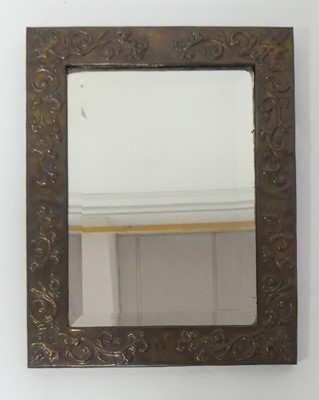 Lot 765 - An Arts & Crafts floral embossed copper framed...