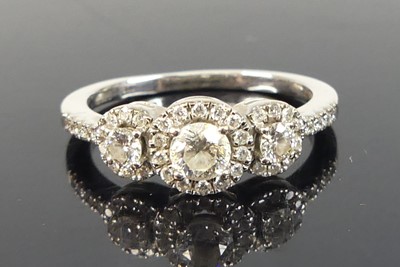 Lot 2171 - An 18ct white gold diamond triple cluster ring,...