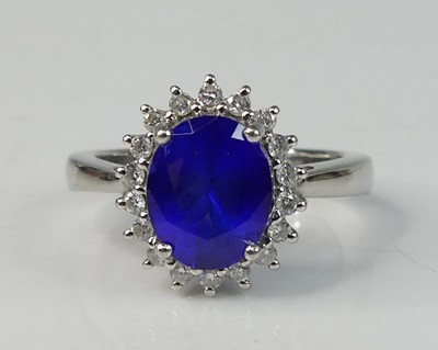 Lot 2169 - A platinum tanzanite and diamond oval cluster...