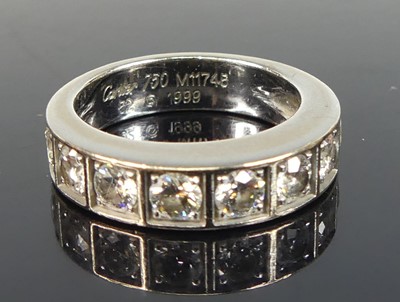 Lot 2231 - A white metal diamond half eternity ring,...