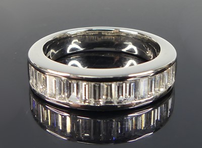 Lot 2208 - A platinum diamond half eternity ring,...