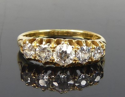 Lot 2184 - A yellow metal diamond half eternity ring,...