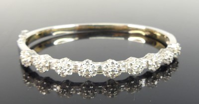 Lot 2226 - A white metal diamond oval hinged bangle,...