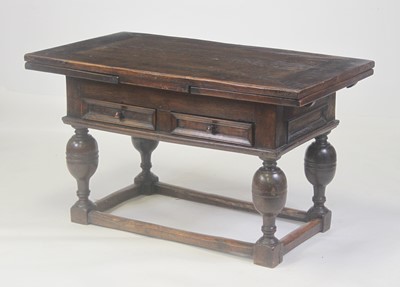 Lot 2483 - An antique continental oak drawleaf refectory...