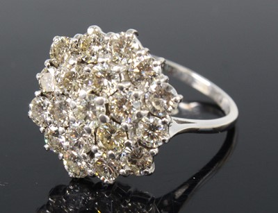 Lot 2229 - An 18ct white gold diamond circular cluster...