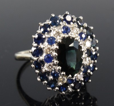 Lot 2194 - An 18ct white gold, sapphire and diamond oval...