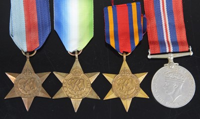 Lot 261 - A group of four WW II medals, to include...