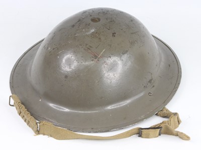 Lot 209 - A WW II British Army Mk II steel helmet, the...