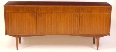 Lot 808 - A 1960s British teak sideboard, having three...