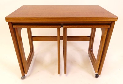 Lot 804 - A 1970s teak nest of three occasional tables,...