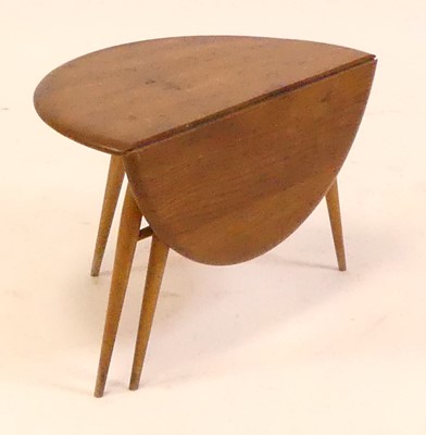 Lot 799 - A 1960s Ercol blond elm low single drop flap...