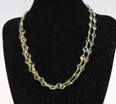 Lot 2218 - A contemporary yellow metal and blue topaz set...