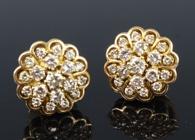 Lot 2202 - A pair of yellow metal and diamond set flower...