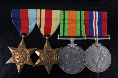 Lot 98 - A group of four WW II medals, to include...