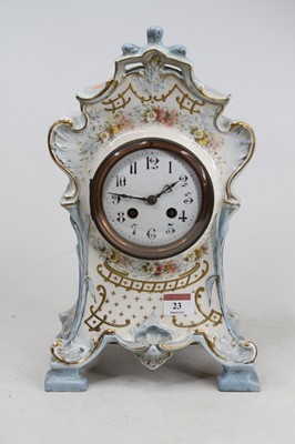 Lot 23 - A Victorian Rococo style pottery mantel clock,...