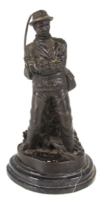 Lot 395 - A bronzed figure of a fisherman with rod bent,...