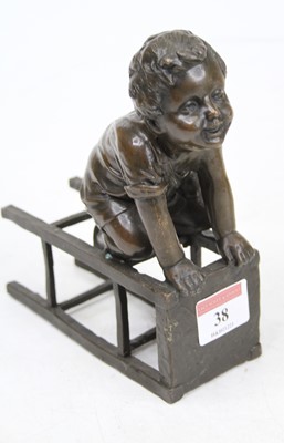 Lot 38 - A bronze figure of a young boy upon a stool,...