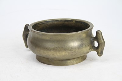 Lot 46 - A Chinese brass censer, flanked by twin...