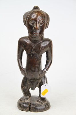 Lot 52 - An African carved hardwood fertility figure,...