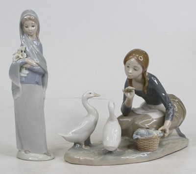 Lot 242 - A Lladro porcelain figure of a girl feeding...