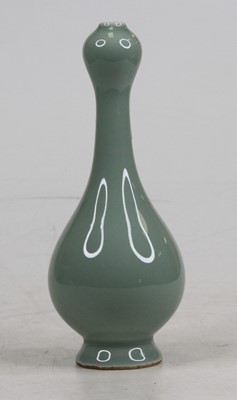 Lot 248 - A Chinese celadon glazed porcelain bottle, the...