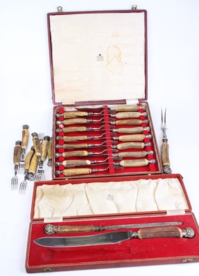 Lot 297 - A cased set of eight antler handled steak...