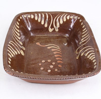 Lot 270 - A brown & cream glazed slipware dish, width 25cm