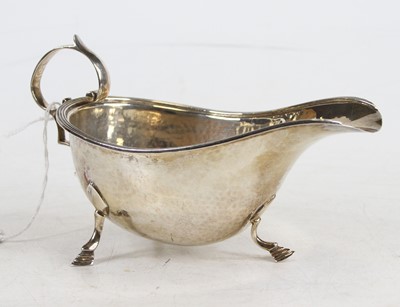 Lot 344 - A George V hammered silver sauceboat, 3.5oz,...