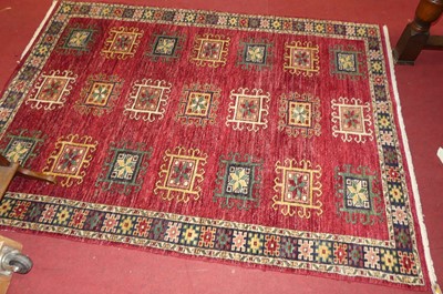 Lot 1177 - A Persian woollen red ground Bokhara rug, 197...