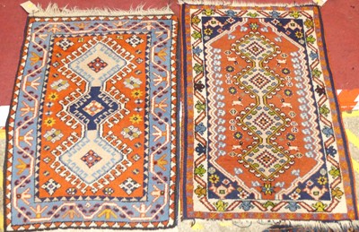 Lot 1186 - A near pair of Persian red ground woollen...